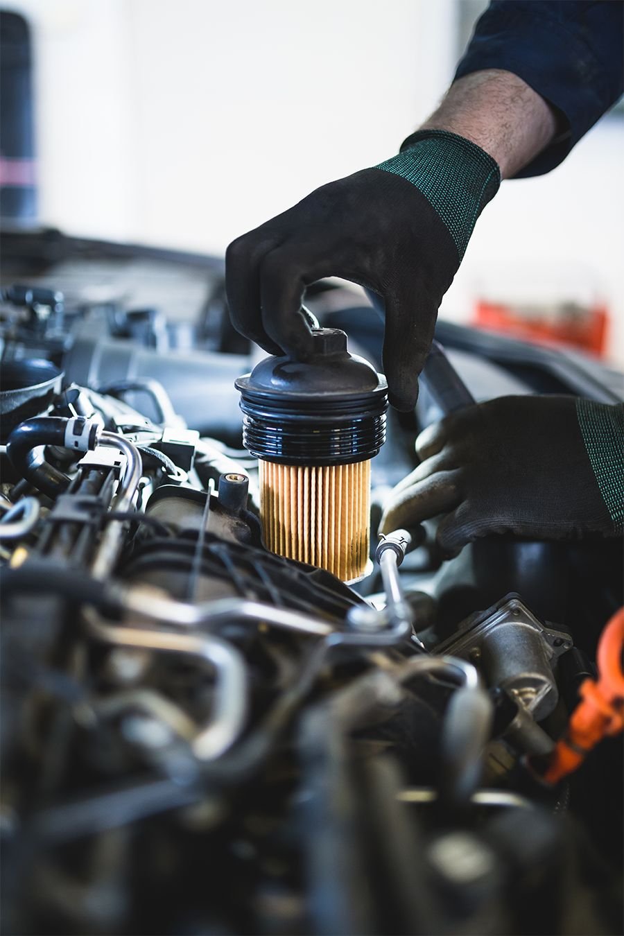 Hands replacing an oil filter during vehicle maintenance