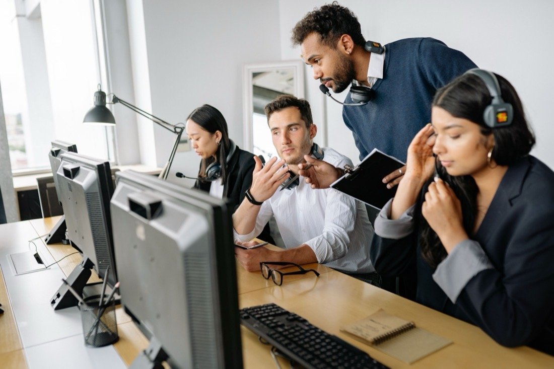 An operations team at their desks with headsets, coordinating deliveries on screen